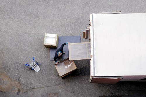 Loading furniture into a removals van on a residential street
