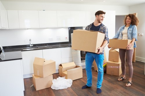 Local moving team handling boxes in East Dulwich near residential streets