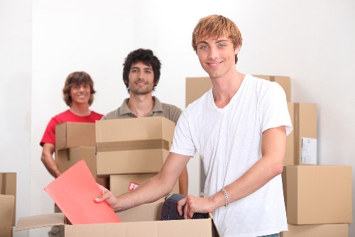 Removal crew managing items carefully in a property